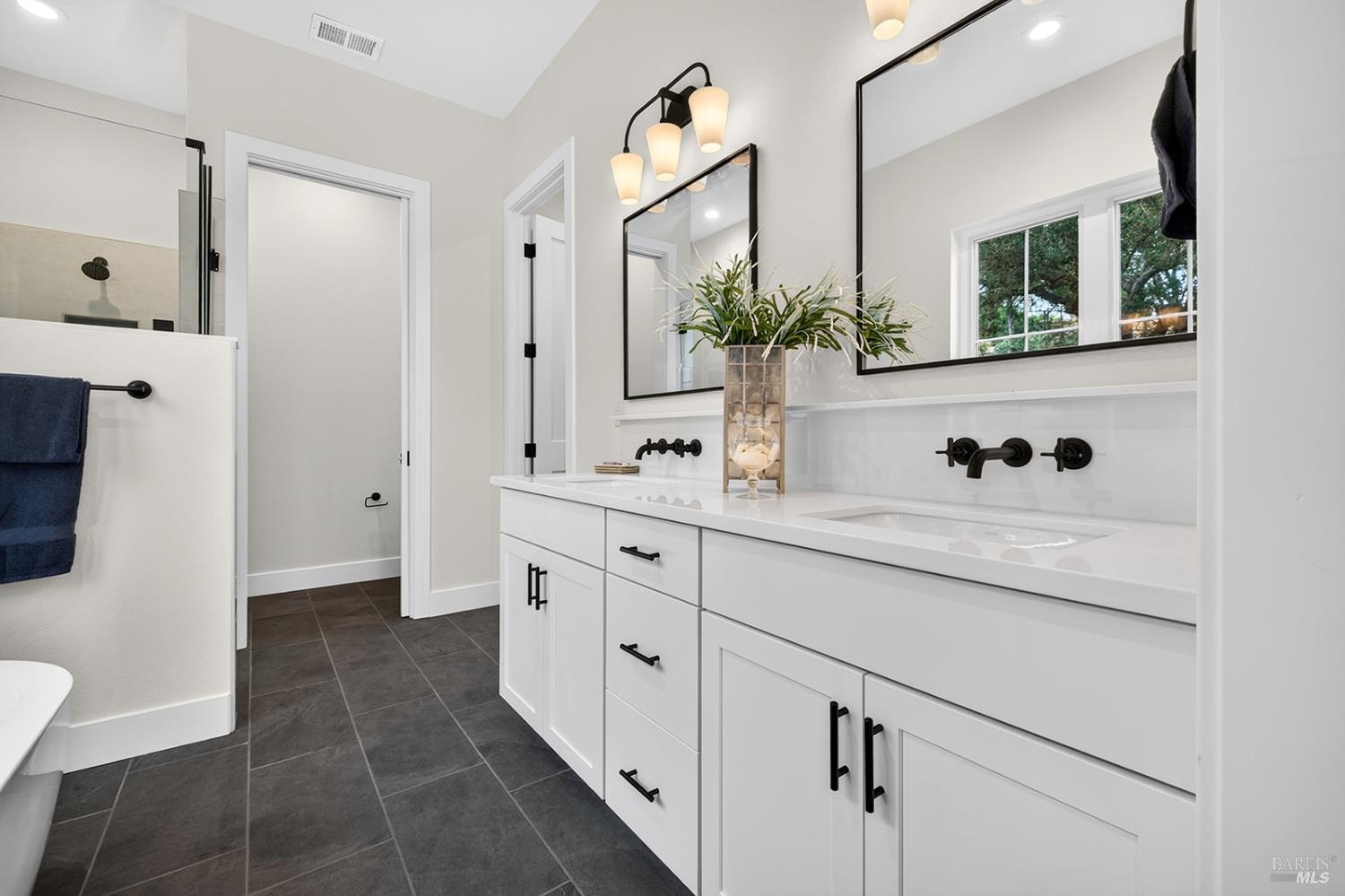 1925 Carlile Place Santa Rosa, CA 95403 - Photo 58 of 70 Here is the primary bathroom with tile flooring and vanity dual sinks and quartz countertop. Water closet to the rear of this photo with the entrance to the walk-in closet on the right.