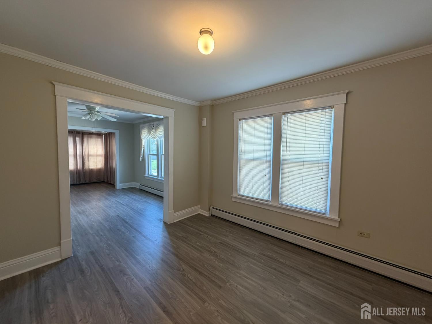 628 Grove Avenue Edison, NJ 08820 - Photo 15 of 21 an empty room with wooden floor and windows