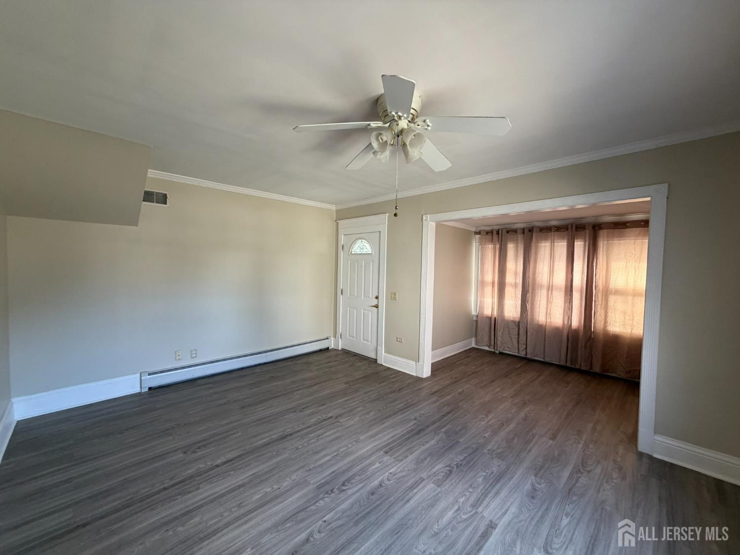 628 Grove Avenue Edison, NJ 08820 - Photo 16 of 21 a view of an empty room with wooden floor and a window