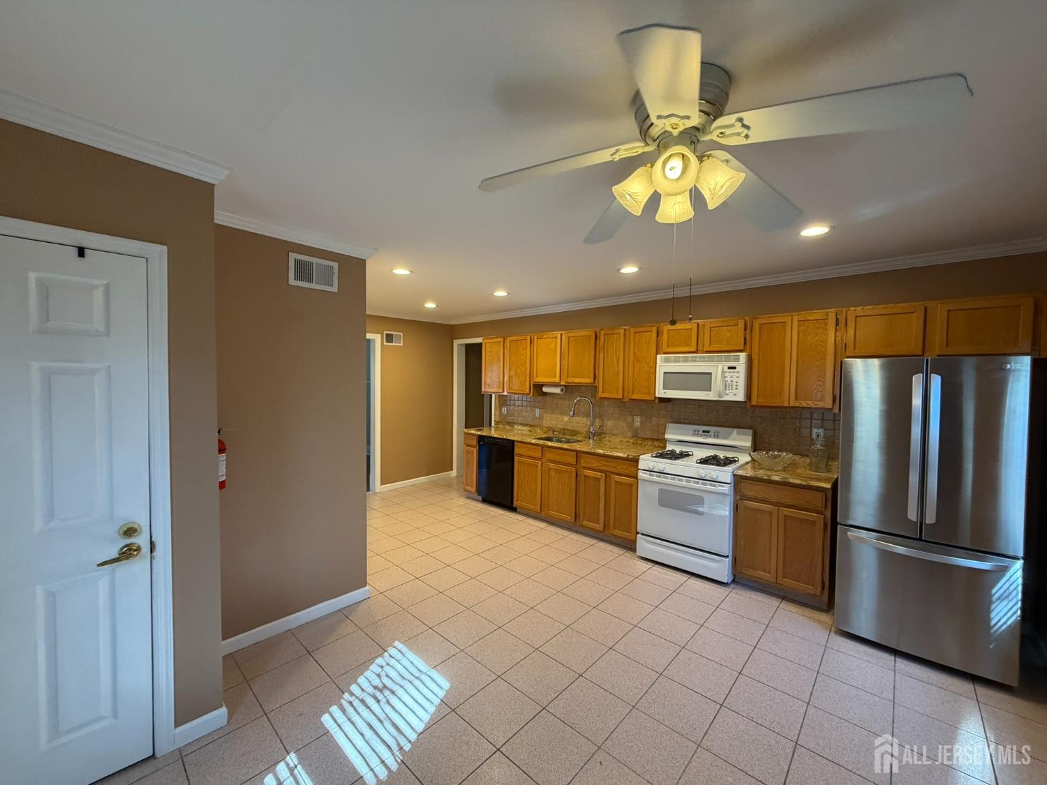 628 Grove Avenue Edison, NJ 08820 - Photo 2 of 21 a kitchen with a refrigerator and a sink