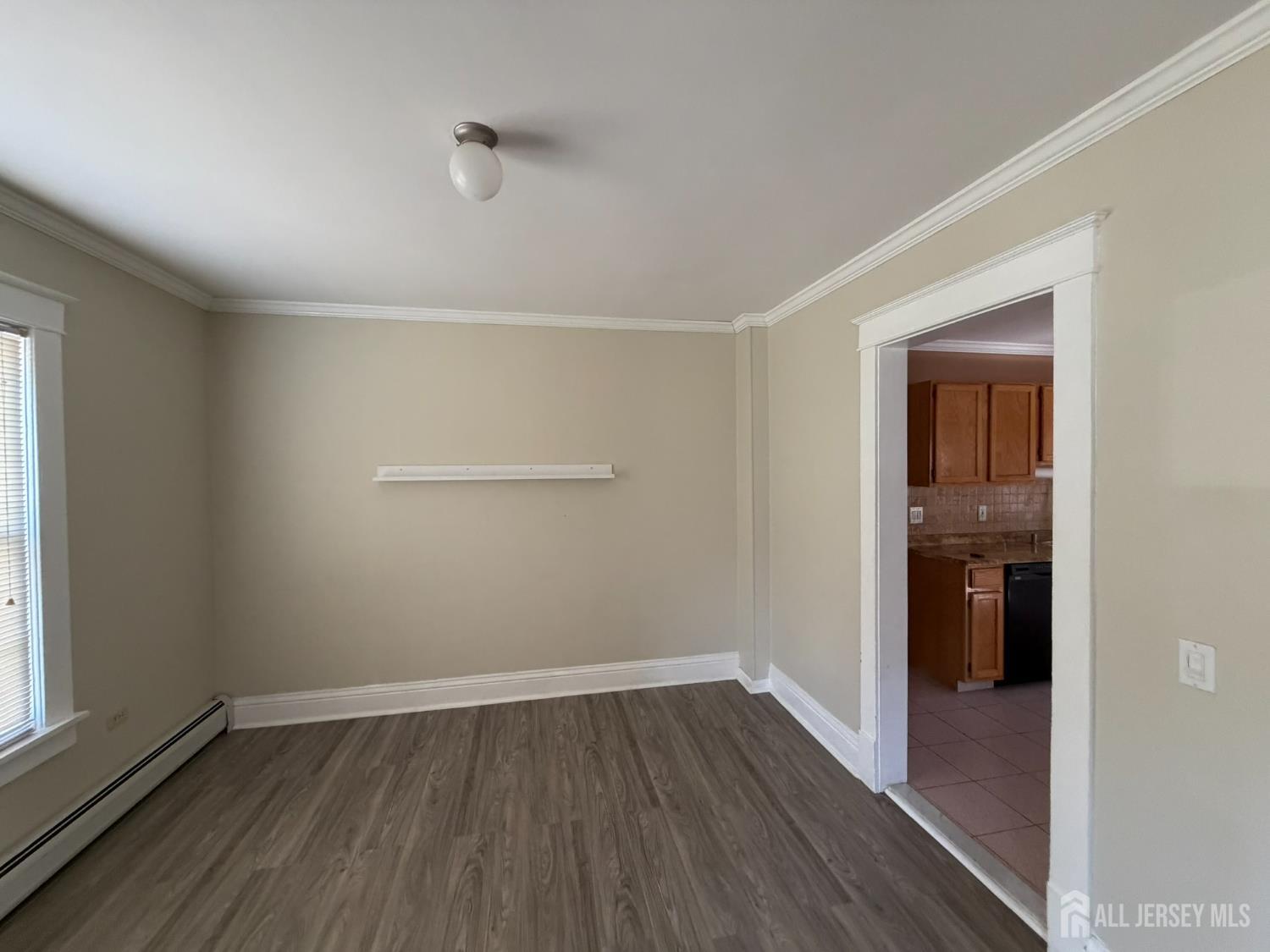 628 Grove Avenue Edison, NJ 08820 - Photo 3 of 21 an empty room with wooden floor and closet