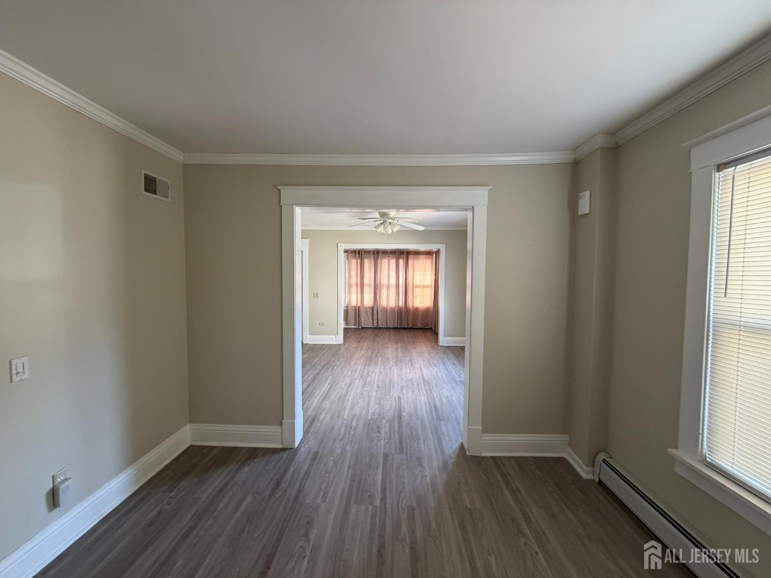 628 Grove Avenue Edison, NJ 08820 - Photo 4 of 21 an empty room with wooden floor and windows