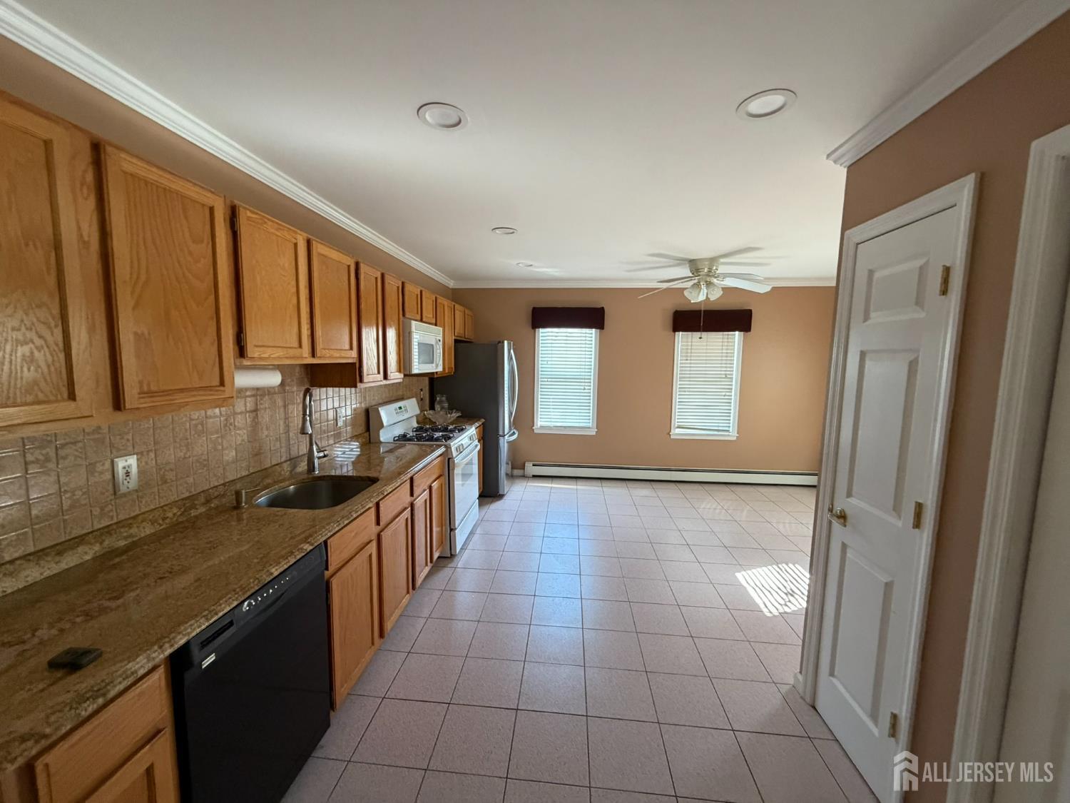 628 Grove Avenue Edison, NJ 08820 - Photo 6 of 21 a kitchen with stainless steel appliances granite countertop a refrigerator and a sink