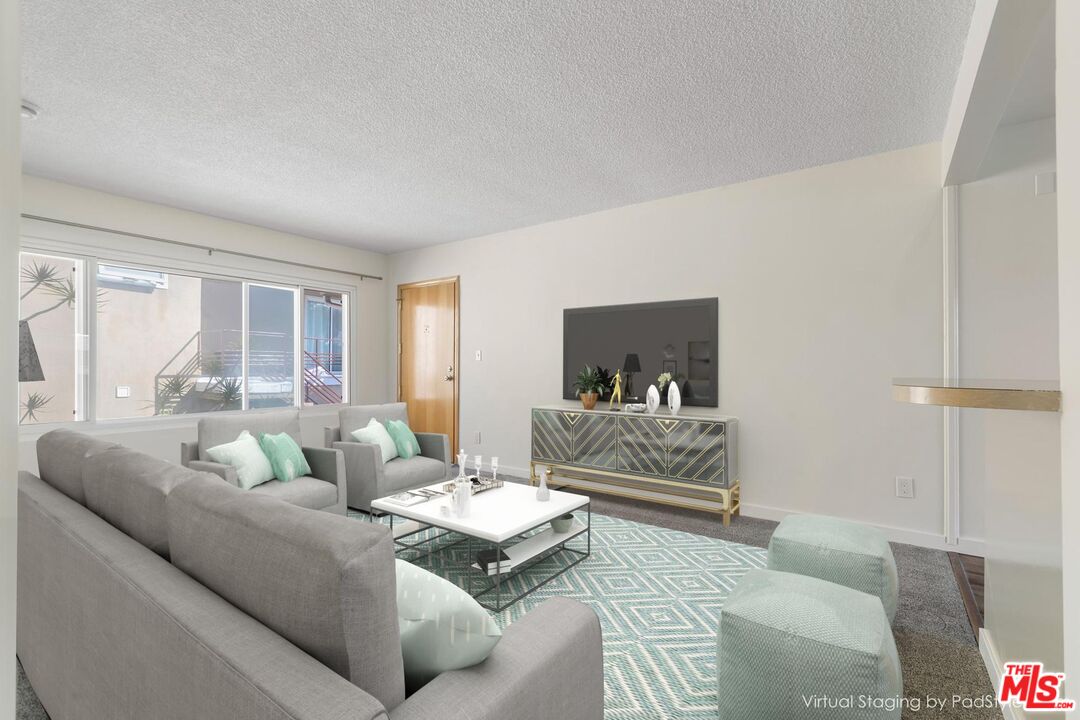 8335 West Manchester Avenue, Unit D Playa del Rey, CA 90293 - Photo 3 of 17 a living room with furniture and a large window