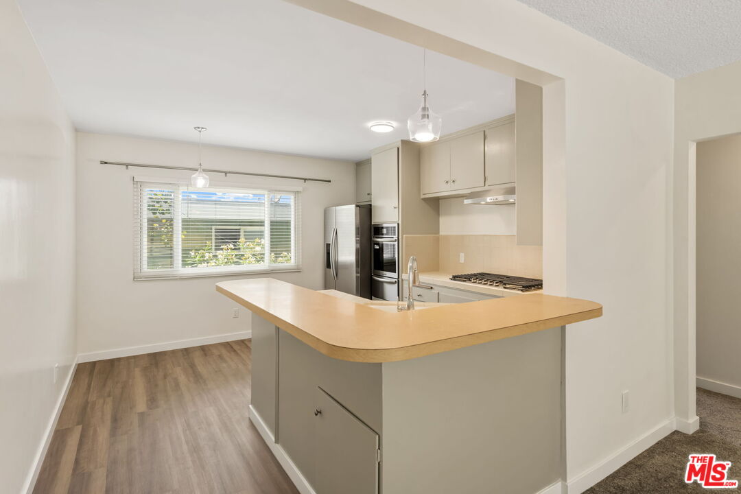 8335 West Manchester Avenue, Unit D Playa del Rey, CA 90293 - Photo 7 of 17 a kitchen with a sink a stove and refrigerator