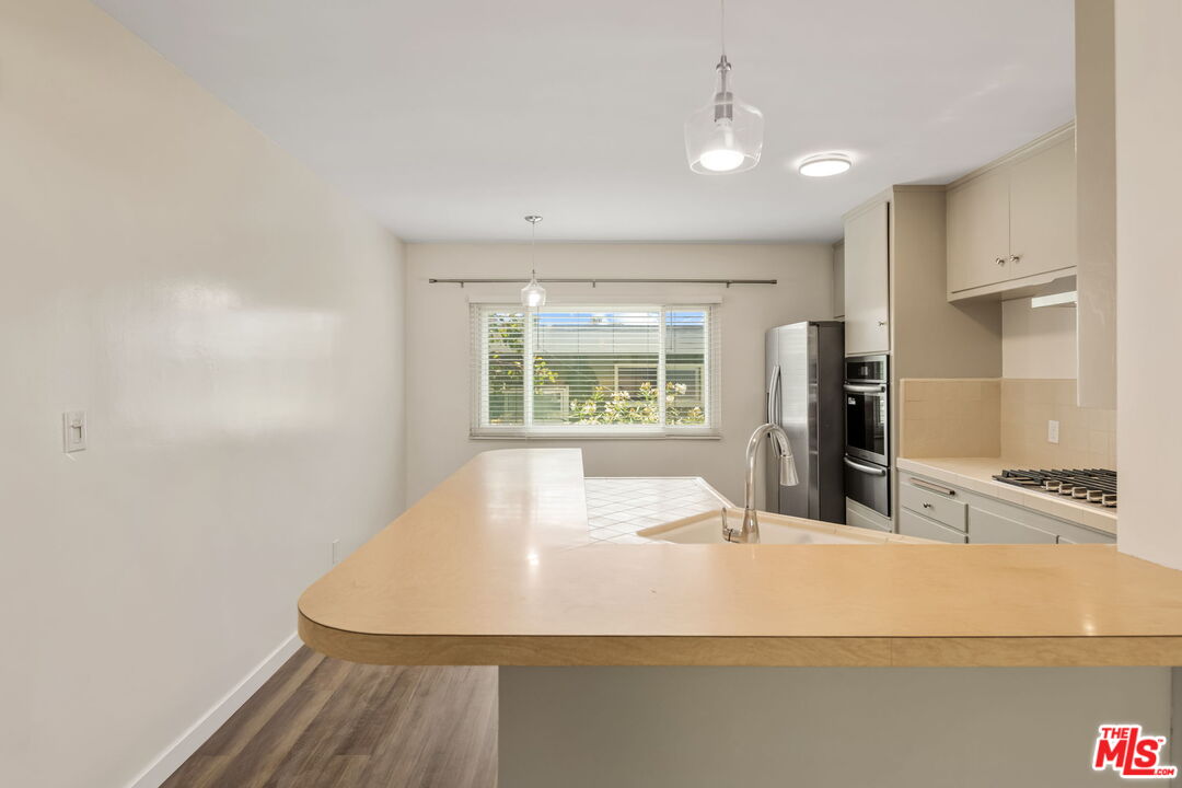 8335 West Manchester Avenue, Unit D Playa del Rey, CA 90293 - Photo 8 of 17 a large white kitchen with a sink and dishwasher
