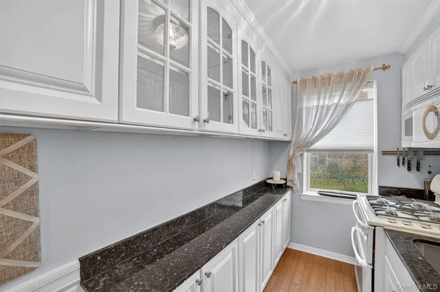 a kitchen with stainless steel appliances granite countertop a stove and a window