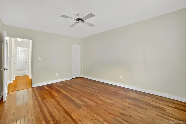 a view of an empty room and wooden floor