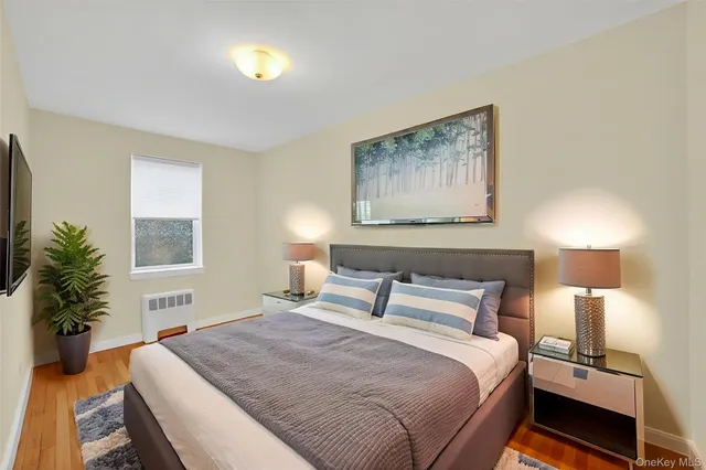 a bedroom with a bed and a painting on the wall