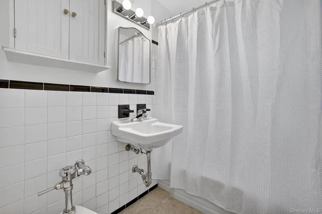 a bathroom with a sink a vanity and a shower curtain