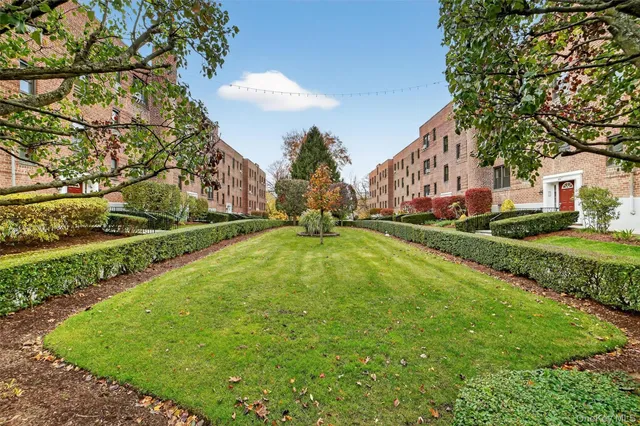 a view of yard with swimming pool and green space
