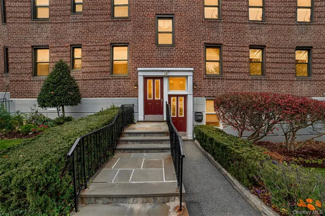 a view of a brick house many windows