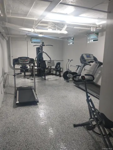 a room with gym equipment and a mirror