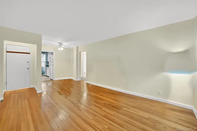 a view of empty room with wooden floor