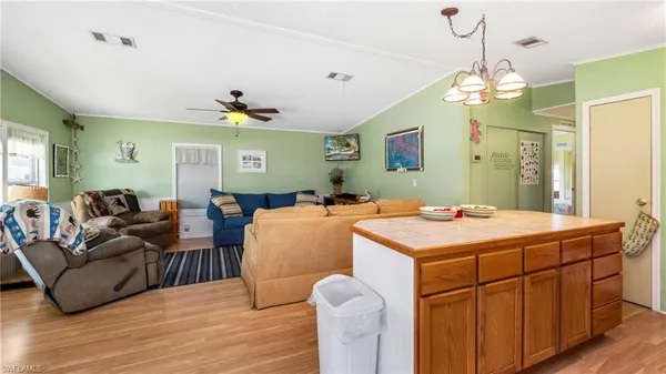 a kitchen with stainless steel appliances granite countertop a table chairs and a refrigerator