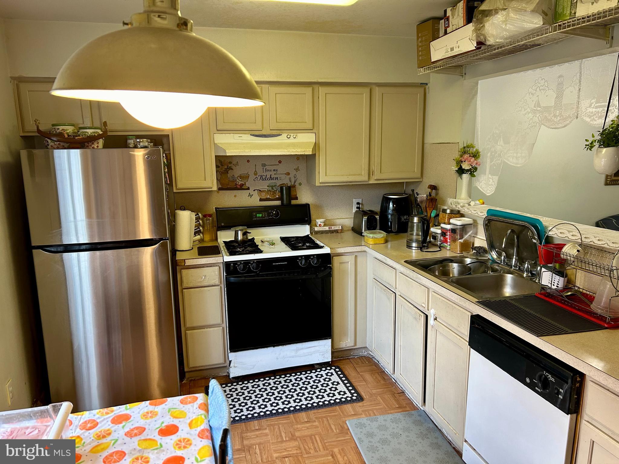 5 Oyster Bay Road Absecon, NJ 08205 - Photo 3 of 15 a kitchen with stainless steel appliances a refrigerator sink and cabinets