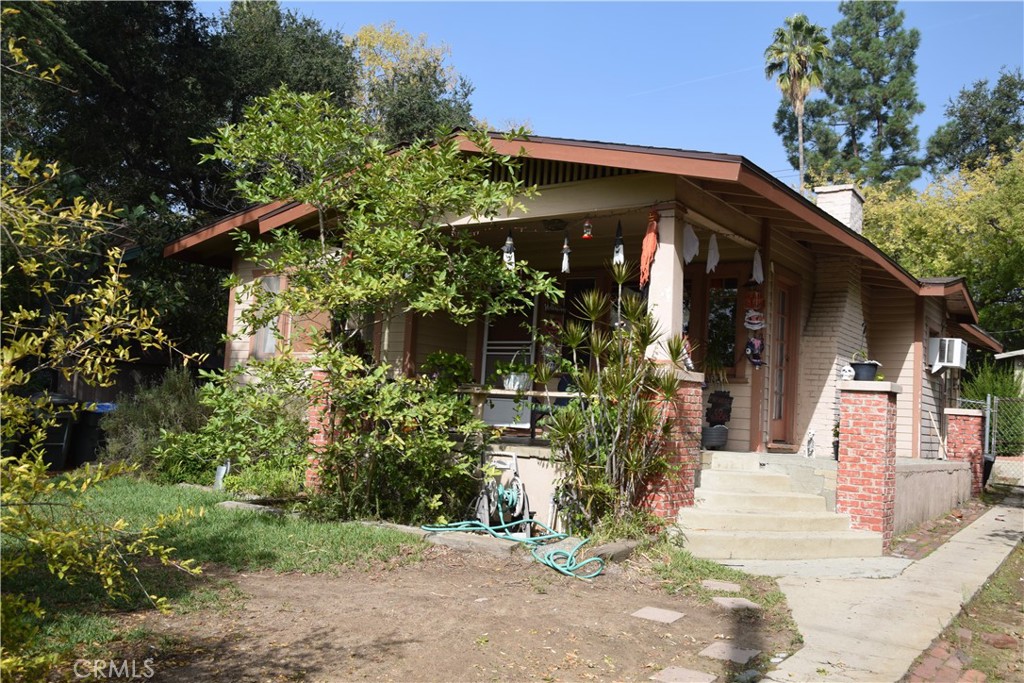 a view of a house with potted plants