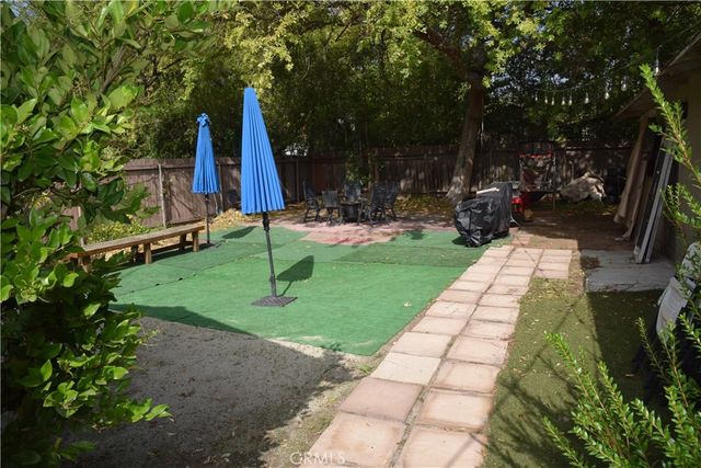 a view of yard with swimming pool and sitting area