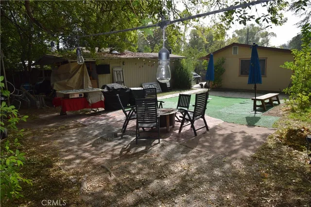 a view of a chairs and table in backyard of the house