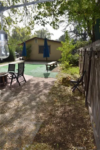 a view of a backyard with table and chairs