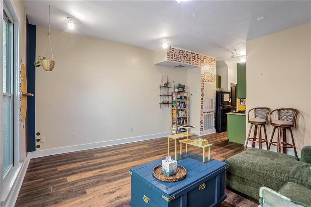 1195 Milton Terrace Southeast, Unit 2203 Atlanta, GA 30315 - Photo 12 of 16 a view of a dining room with furniture and wooden floor