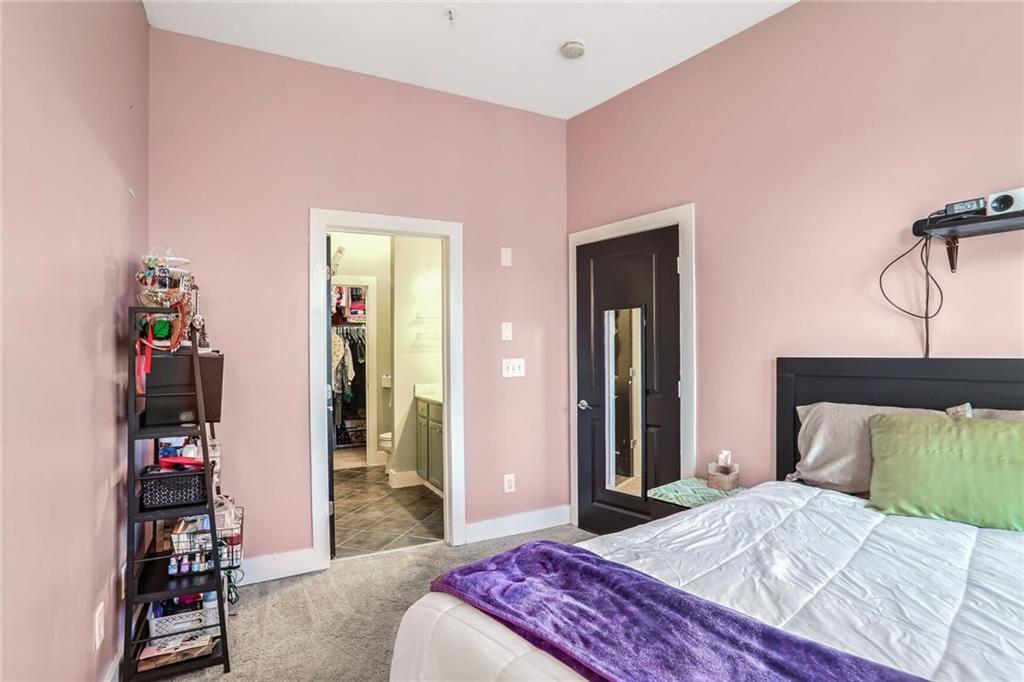 1195 Milton Terrace Southeast, Unit 2203 Atlanta, GA 30315 - Photo 13 of 16 a bedroom with a bed and cabinets