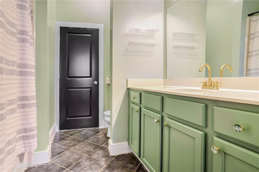 1195 Milton Terrace Southeast, Unit 2203 Atlanta, GA 30315 - Photo 14 of 16 a bathroom with a sink and a mirror