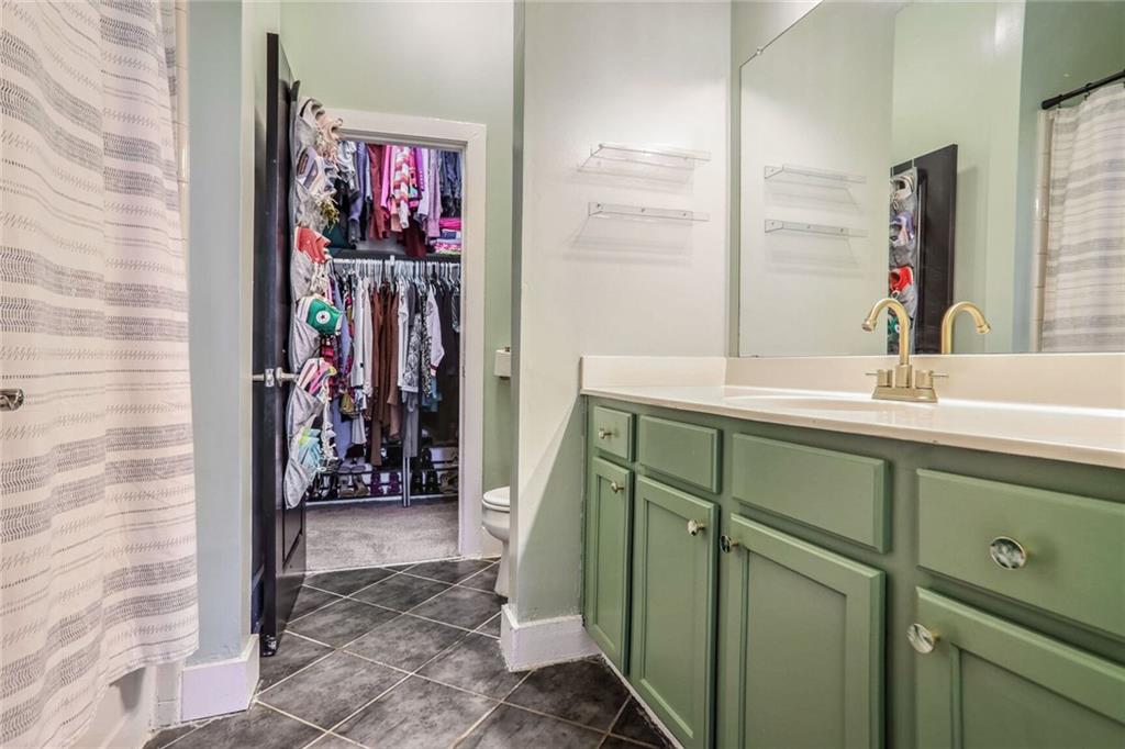 1195 Milton Terrace Southeast, Unit 2203 Atlanta, GA 30315 - Photo 15 of 16 a bathroom with a sink and a mirror
