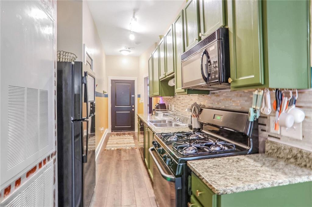1195 Milton Terrace Southeast, Unit 2203 Atlanta, GA 30315 - Photo 8 of 16 a kitchen with stainless steel appliances granite countertop a stove a sink and a refrigerator