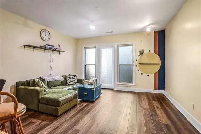 a living room with furniture and wooden floor