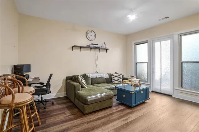 a living room with furniture and a wooden floor
