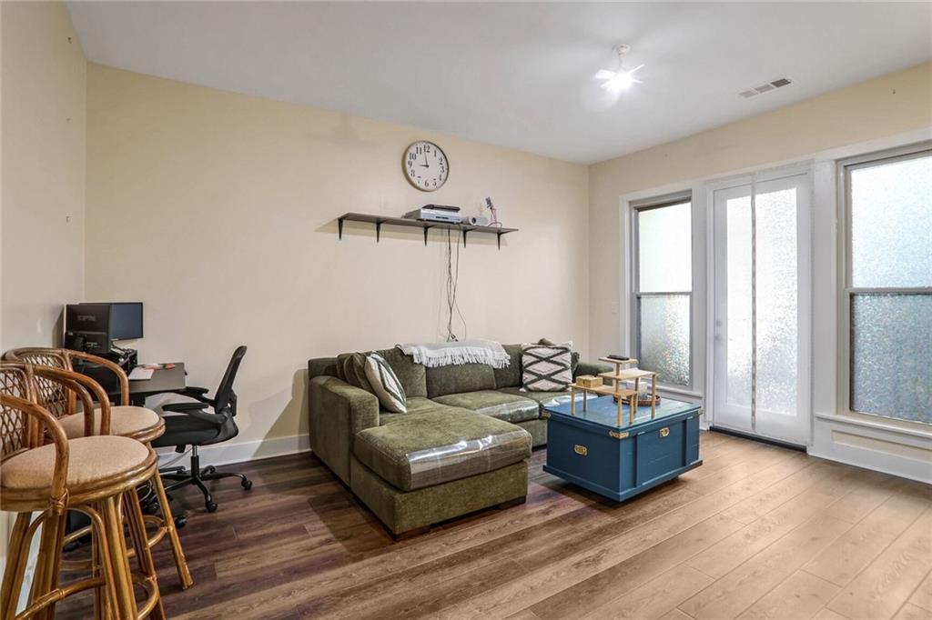 1195 Milton Terrace Southeast, Unit 2203 Atlanta, GA 30315 - Photo 10 of 16 a living room with furniture and wooden floor