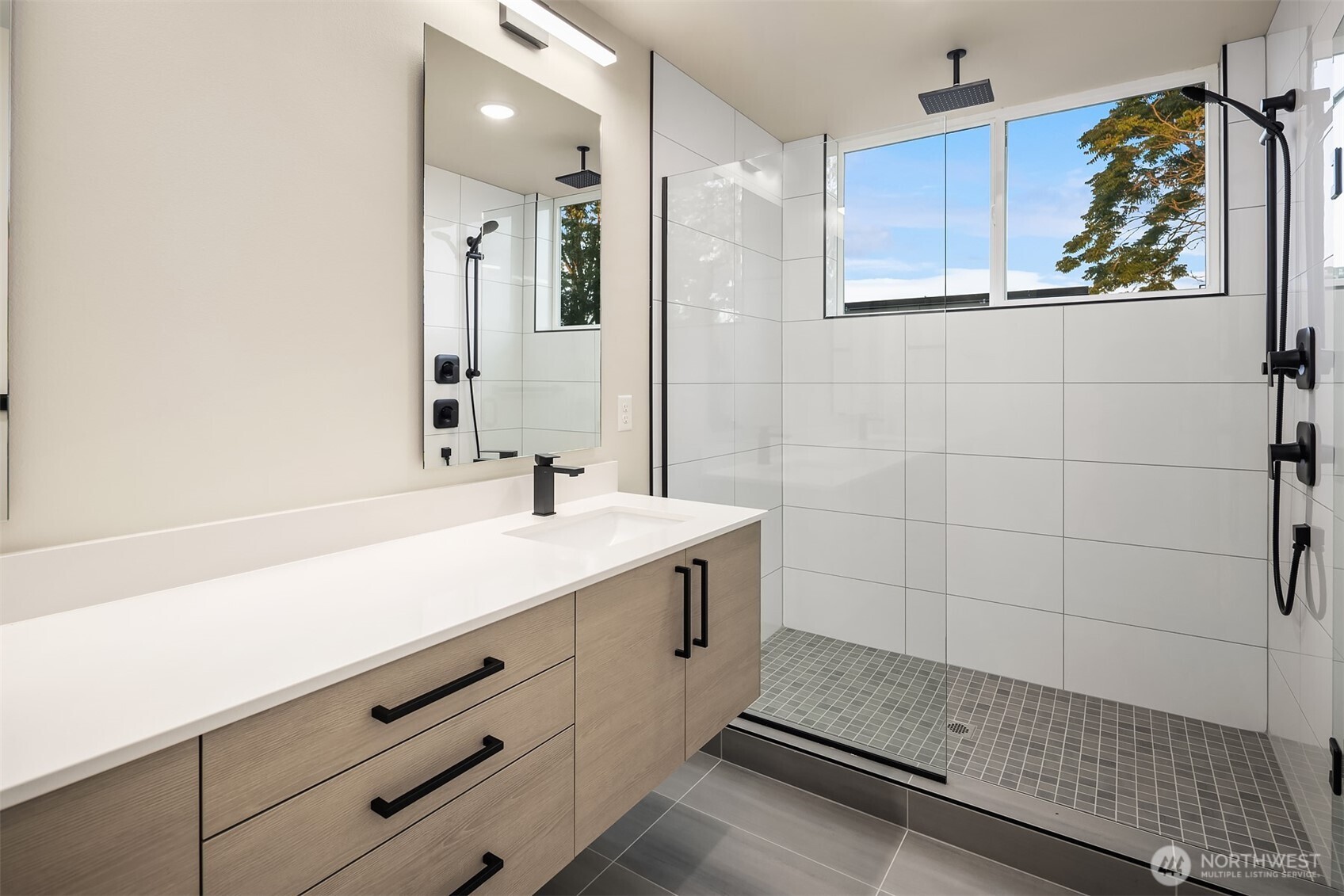 1319 14th Avenue South, Unit A Seattle, WA 98144 - Photo 16 of 27 a bathroom with a double vanity sink a mirror and a shower