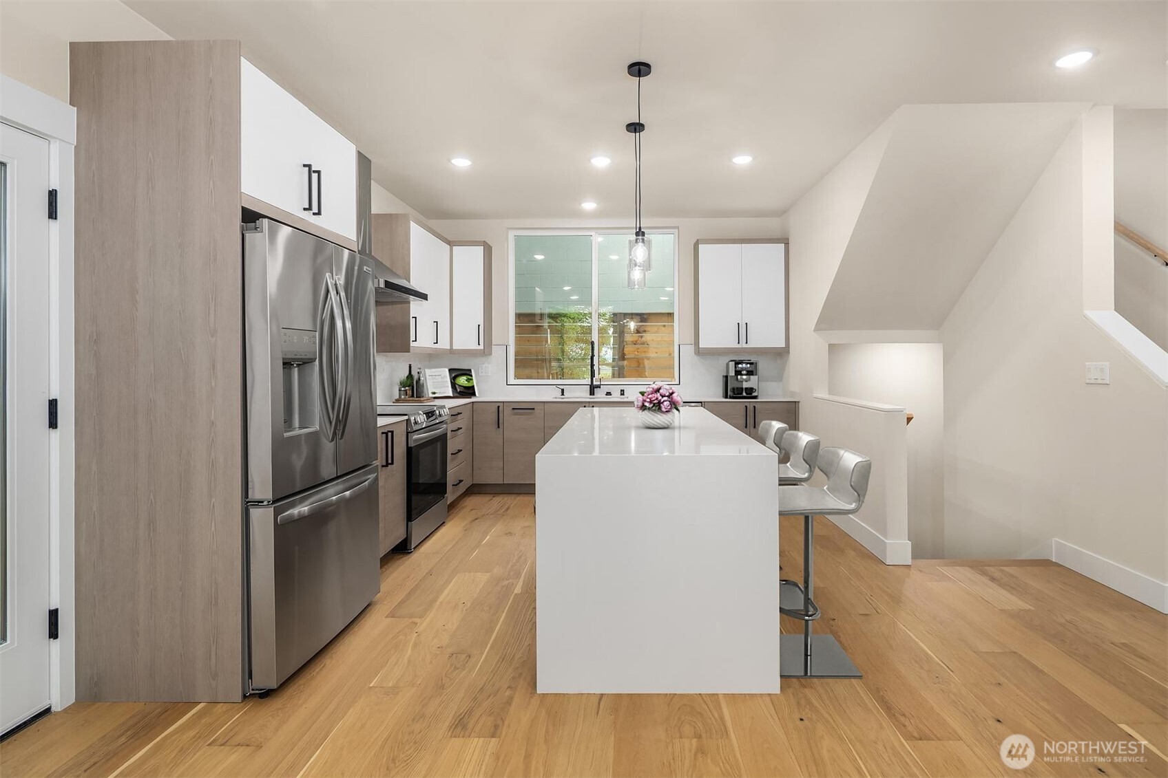 1319 14th Avenue South, Unit A Seattle, WA 98144 - Photo 6 of 27 a kitchen with kitchen island a sink stove and refrigerator
