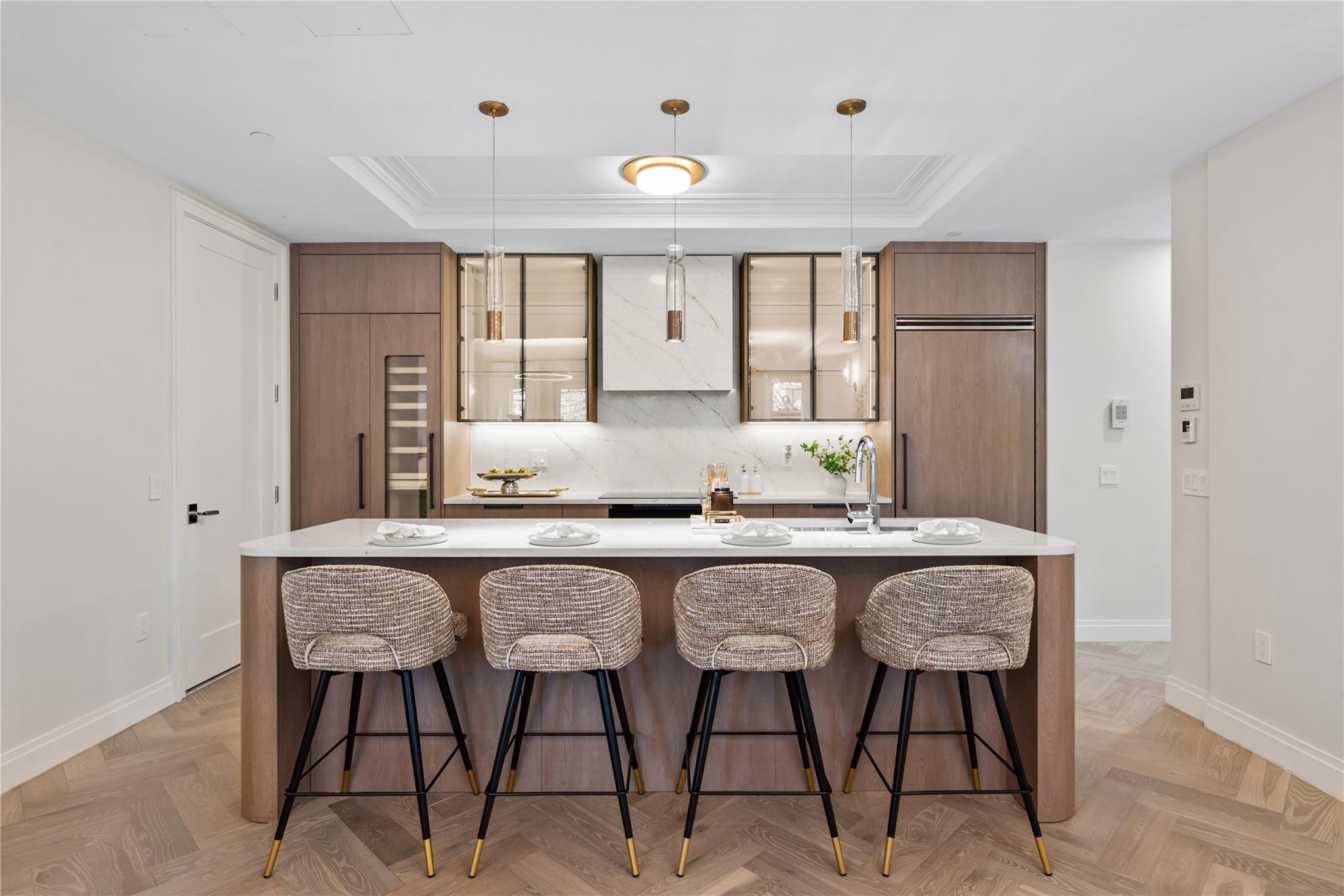 78-29 Austin Street, Unit TH7 Queens, NY 11375 - Photo 4 of 25 Kitchen featuring a raised ceiling, baseboards, a spacious island, a breakfast bar, and ornamental molding