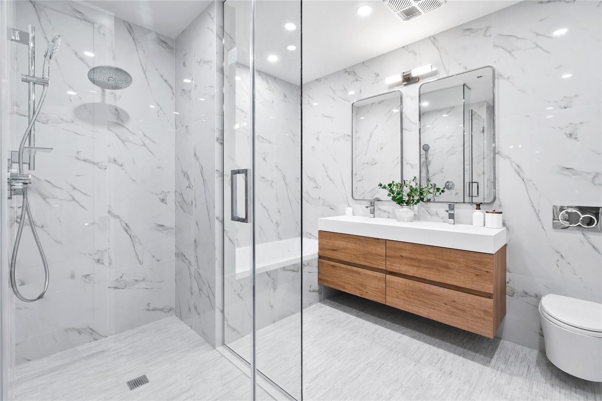 78-29 Austin Street, Unit TH7 Queens, NY 11375 - Photo 9 of 25 Bathroom with tile walls, a marble finish shower, double vanity, toilet, and recessed lighting