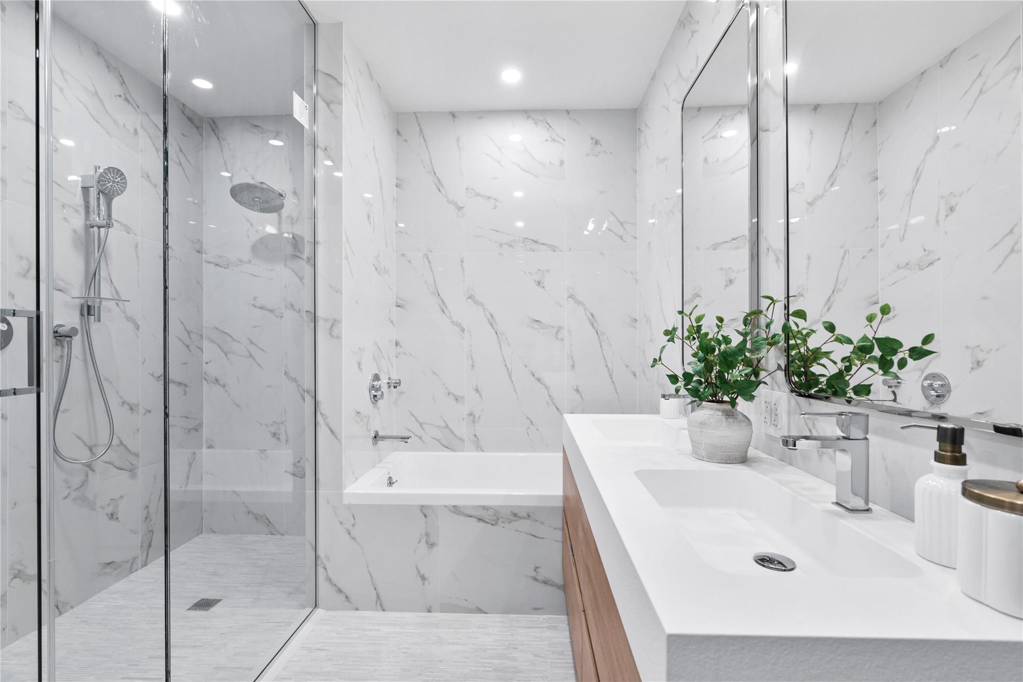 78-29 Austin Street, Unit TH7 Queens, NY 11375 - Photo 10 of 25 Full bath with double vanity, a marble finish shower, a tub with marble appearance, and recessed lighting