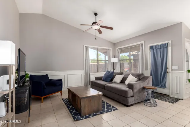 a living room with furniture and a chandelier