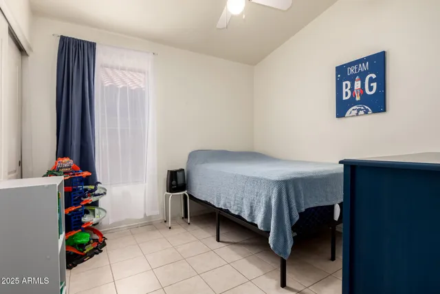 a bedroom with a bed and a window