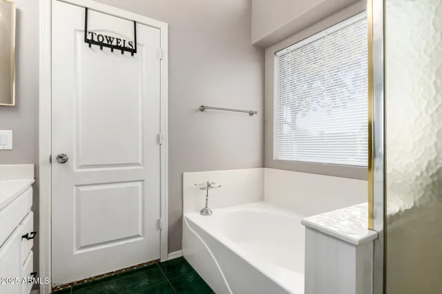 a white bath tub sitting next to a shower