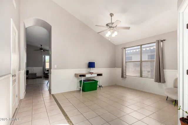 a very nice looking room with a mirror and a ceiling fan