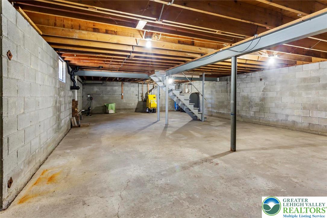 919 Breidinger Road Nazareth, PA 18064 - Photo 24 of 33 a view of a room with wooden stairs and a refrigerator