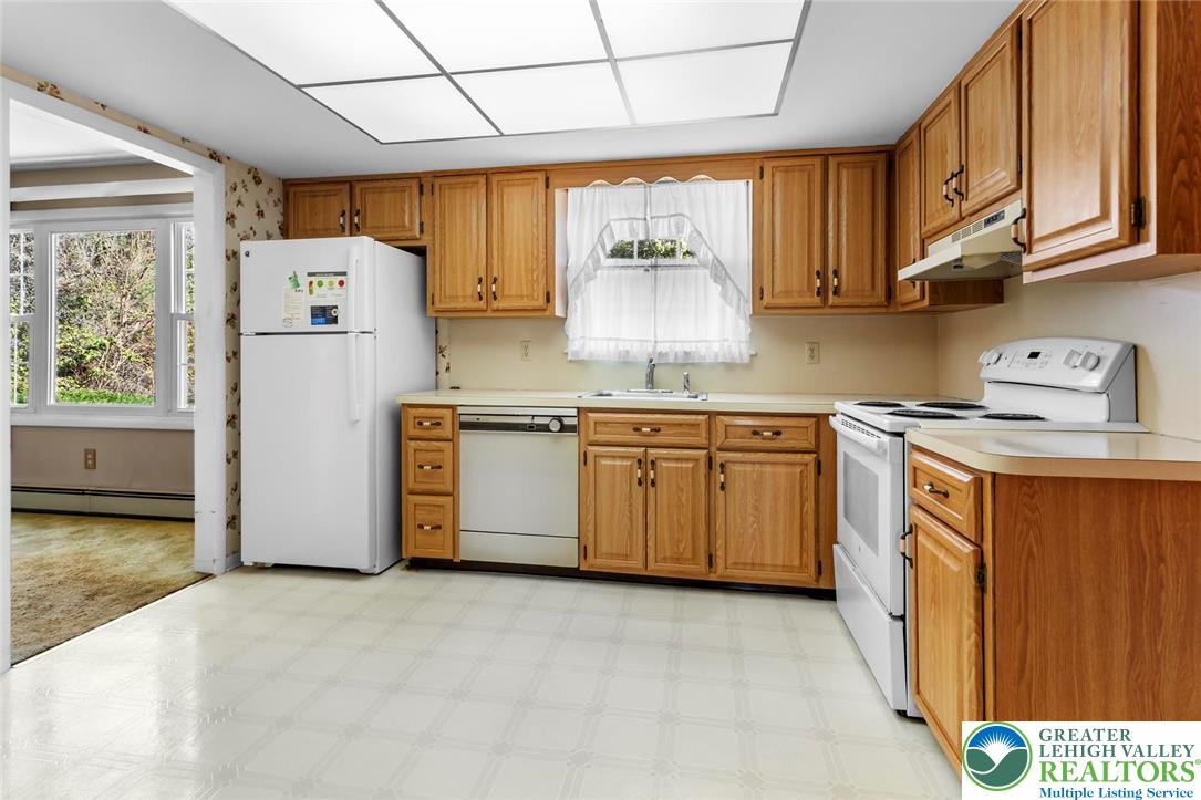 919 Breidinger Road Nazareth, PA 18064 - Photo 4 of 33 a kitchen with stainless steel appliances granite countertop a stove a sink dishwasher and a refrigerator with wooden cabinets