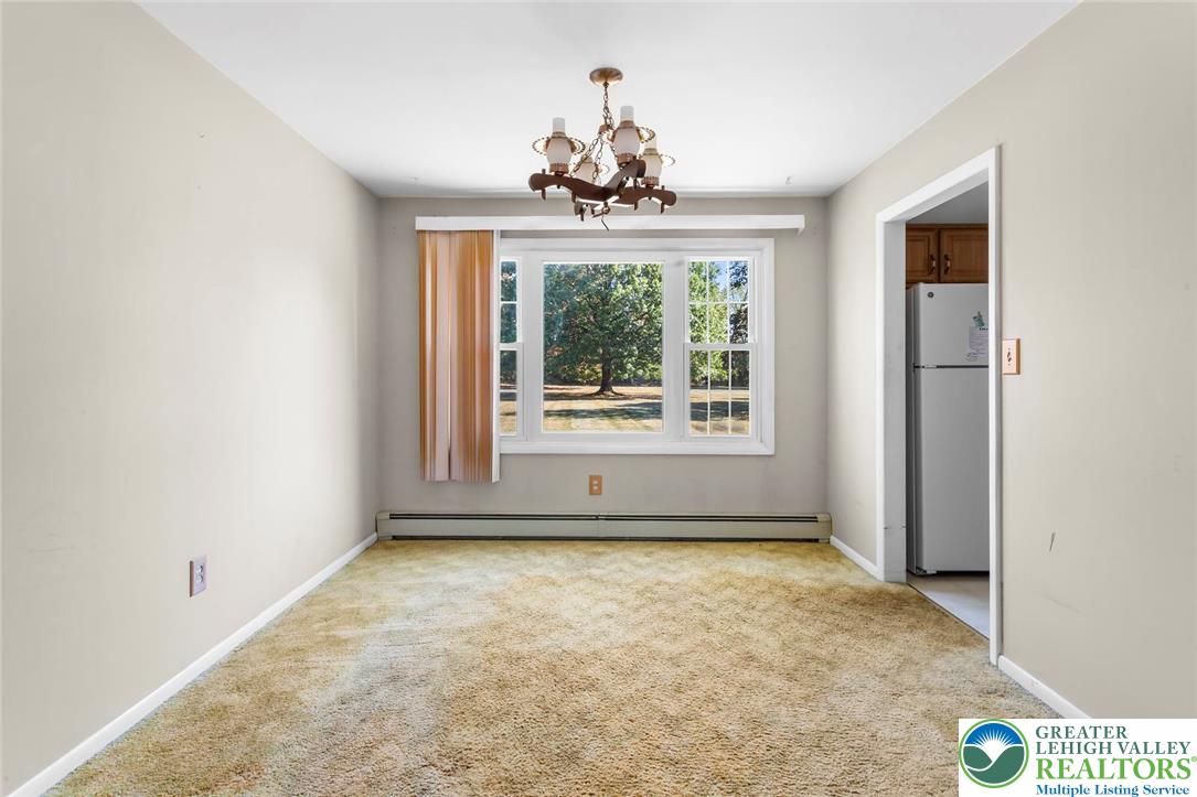 919 Breidinger Road Nazareth, PA 18064 - Photo 7 of 33 an empty room with a windows and chandelier