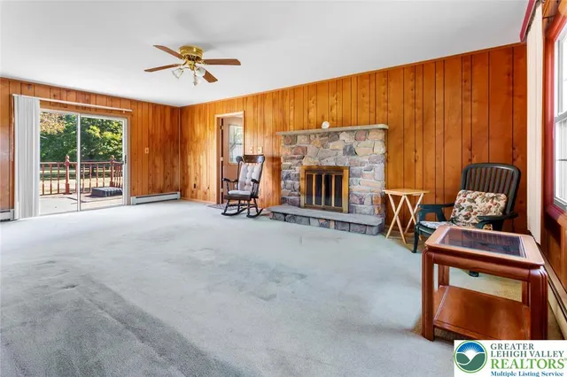 a view of an empty room with a fireplace and a window