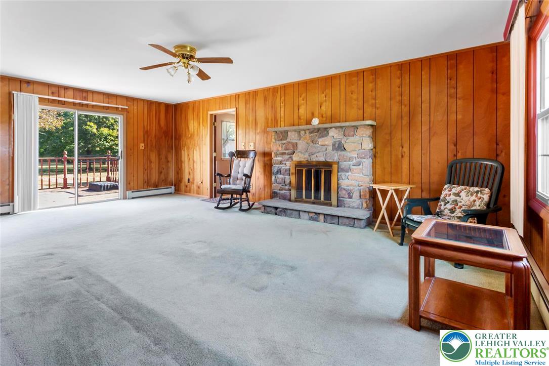 919 Breidinger Road Nazareth, PA 18064 - Photo 9 of 33 a view of an empty room with a fireplace and a window