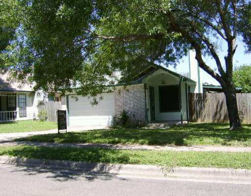 a house that has a tree in front of it