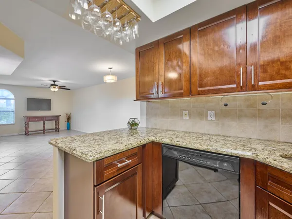a kitchen with a granite countertop sink and cabinets