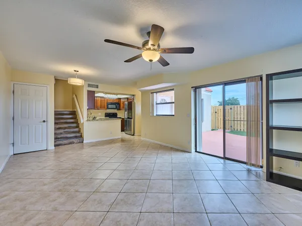a view of an empty room with window and cabinet