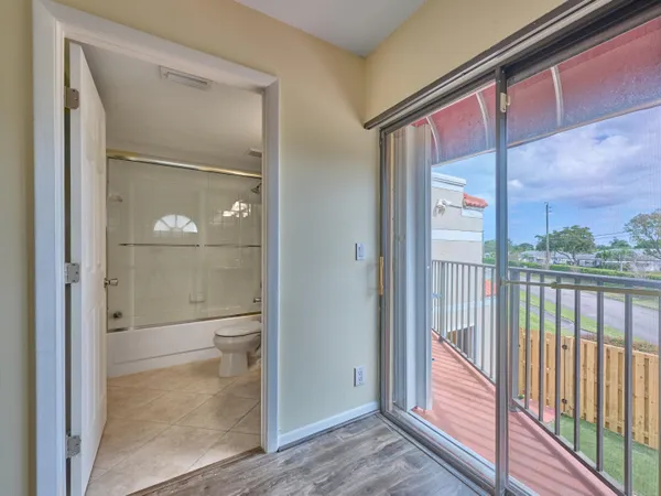 a bathroom with a glass shower door and mirror